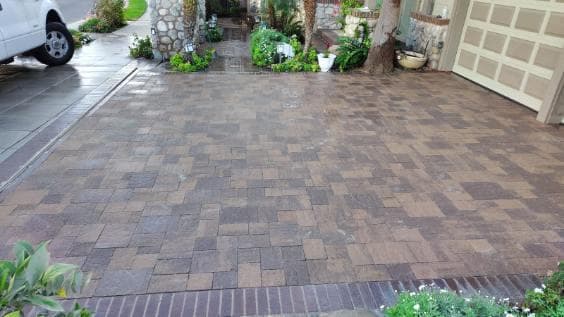 picture of a newly installed pavers driveway with custom different colored and textured pavers for a luxury look